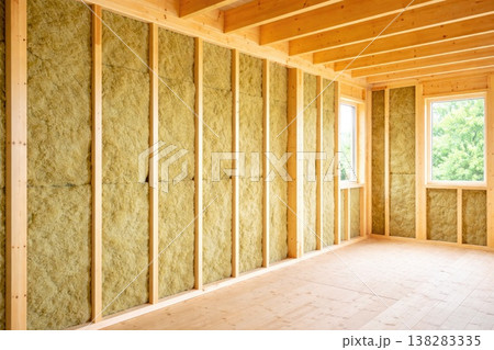 Wooden house interior under construction with thermal insulation panels in walls 138283335