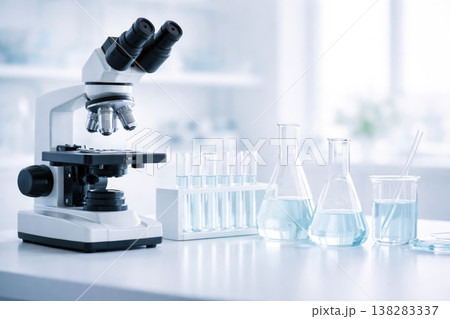 Laboratory microscope with glassware and test tubes in clean scientific environment 138283337