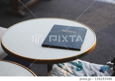 The black leather menu book on the table. The black leather menu book on the table. 138283486