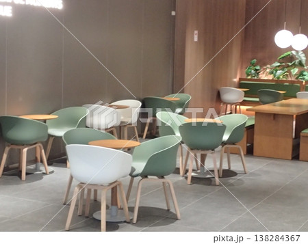 シンプルなカフェのテーブル席 落ち着いた色合いの休憩スペース 138284367