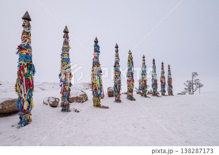 Snowing at Shaman poles located at cape Burkhan on Olkhon island in Lake Baikal, Russia. The poles represent the 13 deities of the island. 138287173