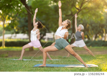 Young woman doing yoga in warrior pose 138288244