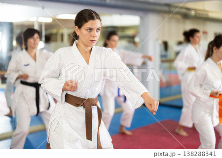 Women in self-defense training in white kimono with belts Women in self-defense training in white kimono with belts 138288341