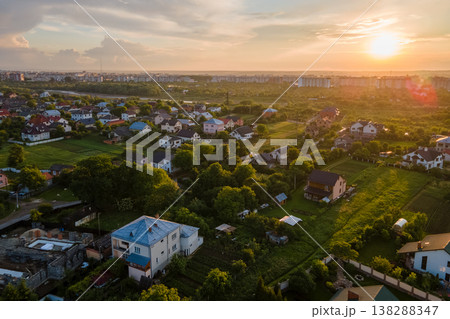 Aerial view of residential houses in suburban rural area at sunset Aerial view of residential houses in suburban rural area at sunset 138288347