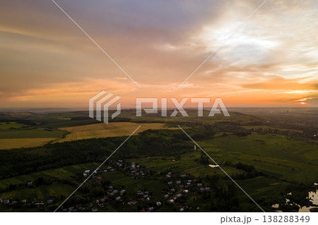 Aerial view of residential houses in suburban rural area at sunset Aerial view of residential houses in suburban rural area at sunset 138288349