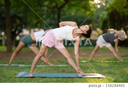 Adult woman doing yoga in park Adult woman doing yoga in park 138288405