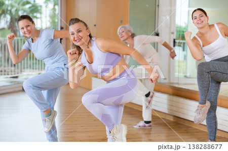 Active middle-aged woman practicing aerobic dance in training hall Active middle-aged woman practicing aerobic dance in training hall 138288677