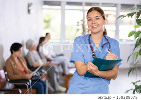 Woman doctor wear white medical uniform and stethoscope with folder of documents 138288678