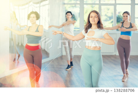 During dance lesson, girls practice and memorize movements to perform slow classical waltz dance. 138288706