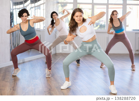 Enthusiastic young girl honing hip-hop moves in dance studio Enthusiastic young girl honing hip-hop moves in dance studio 138288720