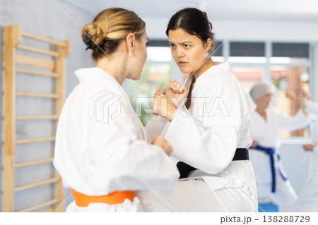 Two young women training karate techniques Two young women training karate techniques 138288729