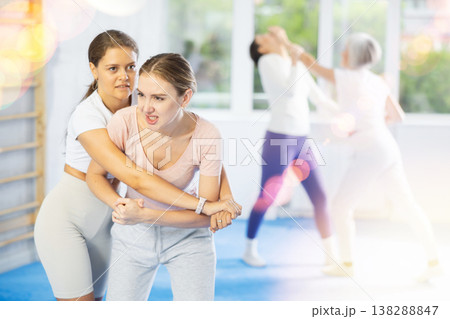 Two young women training self-defense techniques Two young women training self-defense techniques 138288847