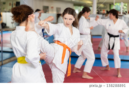 Women practice karate techniques in pairs Women practice karate techniques in pairs 138288891