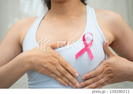 Breast cancer, pink ribbon at Asian senior lady for supporting awareness, symbol of World Breast Cancer Day. Breast cancer, pink ribbon at Asian senior lady for supporting awareness, symbol of World Breast Cancer Day. 138290211