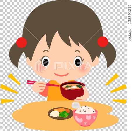 A girl eating a meal of rice, pickles, and miso soup. A girl eating a meal of rice, pickles, and miso soup. 138291219