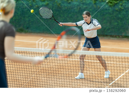 Young woman playing tennis against opponent Young woman playing tennis against opponent 138292060