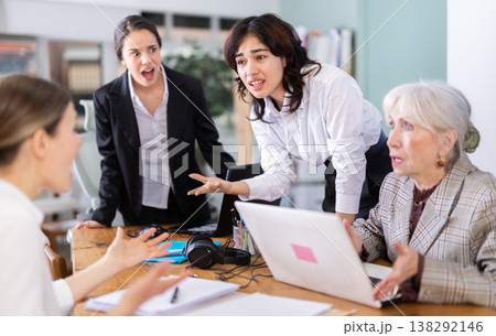 Group of women arguing and scolding each other at office table 138292146
