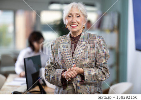 Mature woman welcoming clients at workplace Mature woman welcoming clients at workplace 138292150