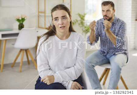 Upset woman and angry partner during couple conflict and argument in living room Upset woman and angry partner during couple conflict and argument in living room 138292341