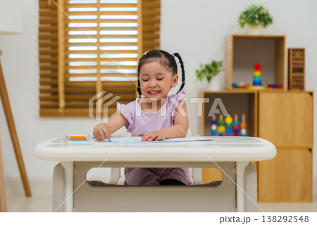 happy preschool child girl drawing and painting with colorful oil pastels on paper happy preschool child girl drawing and painting with colorful oil pastels on paper 138292548