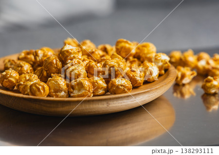 Delicious popcorn served in a wooden bowl on a table 138293111