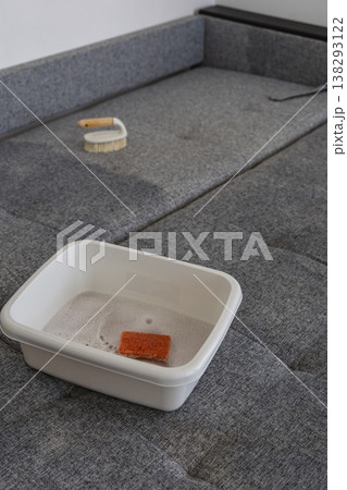 Cleaning supplies on a bed with a gray fabric surface during daytime Cleaning supplies on a bed with a gray fabric surface during daytime 138293122