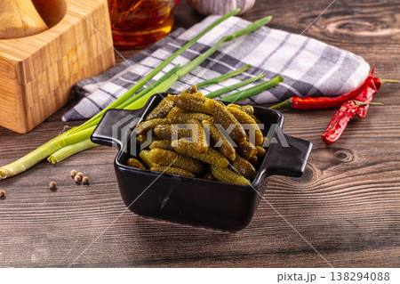 Rustic still life with a bowl of pickled gherkins, green onions, and chili peppers on a wooden table Rustic still life with a bowl of pickled gherkins, green onions, and chili peppers on a wooden table 138294088