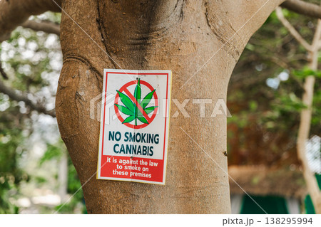 No smoking cannabis prohibition sign attached to tree in tropical resort area Koh Samui Thailand No smoking cannabis prohibition sign attached to tree in tropical resort area Koh Samui Thailand 138295994