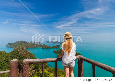 Young woman standing on viewpoint in Ang Thong National Marine Park overlooking tropical islands and turquoise sea in Thailand Young woman standing on viewpoint in Ang Thong National Marine Park overlooking tropical islands and turquoise sea in Thailand 138296052