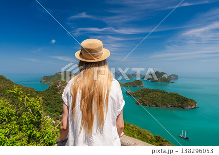 Woman enjoying panoramic view of Ang Thong Marine National Park islands from scenic viewpoint in Thailand Woman enjoying panoramic view of Ang Thong Marine National Park islands from scenic viewpoint in Thailand 138296053