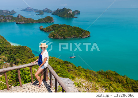 Middle-aged woman enjoying sea view at Ang Thong Marine National Park viewpoint in Thailand Middle-aged woman enjoying sea view at Ang Thong Marine National Park viewpoint in Thailand 138296066
