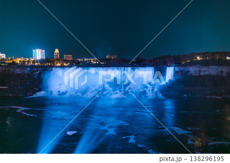 Niagara Falls Illuminated At Night With Blue Lights And City Skyline 138296195