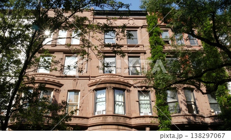 New York City townhouse buildings, residential brownstone row houses in Manhattan or Brooklyn, USA. New York City townhouse buildings, residential brownstone row houses in Manhattan or Brooklyn, USA. 138297067