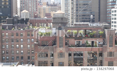 New York City Midtown East urban residential buildings, Manhattan rooftop, USA. Water towers on roof New York City Midtown East urban residential buildings, Manhattan rooftop, USA. Water towers on roof 138297068