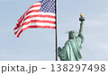 Statue of Liberty on Liberty Island, New York, USA. Flag and monument, patriotic symbol of democracy 138297498