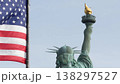 Statue of Liberty on Liberty Island, New York, USA. Flag and monument, patriotic symbol of democracy 138297527