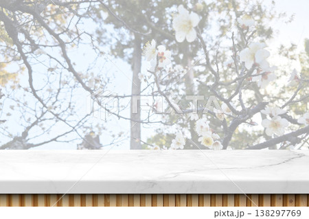 White marble tabletop with blurred blooming cherry blossom trees background White marble tabletop with blurred blooming cherry blossom trees background 138297769