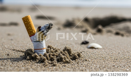 Extreme close-up of discarded cigarette butts buried in the sand on a beach, highlighting environmental pollution and littering. Extreme close-up of discarded cigarette butts buried in the sand on a beach, highlighting environmental pollution and littering. 138298369