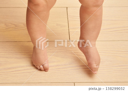 Baby Feet On Wooden Floor Caucasian Child Taking First Steps In Cozy Home Environment 138299032