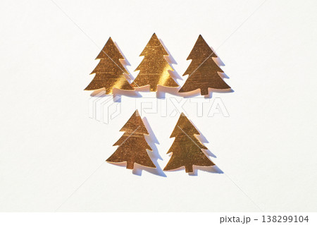 Golden Metallic Tree Decorations On White Background Perfect For Holiday Designs 138299104