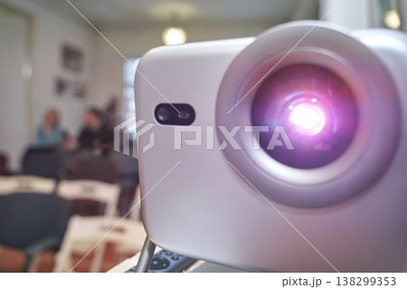 Bright projector in empty conference room with blurred background scene and defocused people 138299353