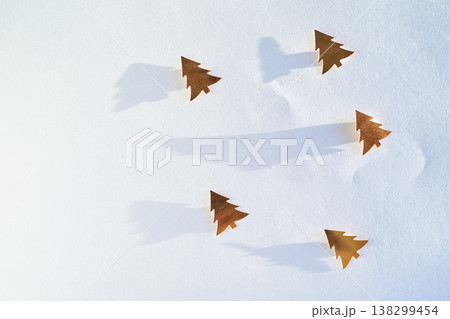 Minimalist Winter Scene With Gold Tree Cutouts Casting Shadows On White Background Minimalist Winter Scene With Gold Tree Cutouts Casting Shadows On White Background 138299454