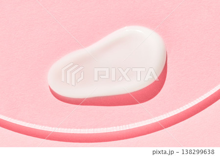Soft creamy white moisturizer blob on pink textured background for skincare and beauty Soft creamy white moisturizer blob on pink textured background for skincare and beauty 138299638