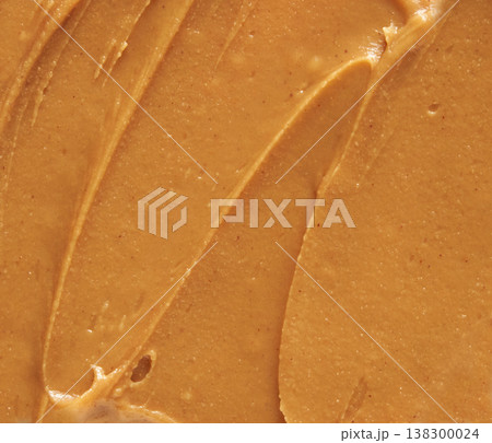 Close-Up Of Creamy Smooth Peanut Butter Texture With Swirls For Delicious Spread And Snack Ideas 138300024