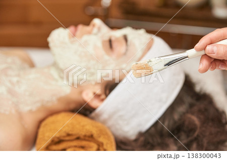 Young Caucasian Female Relaxing During Facial Spa Treatment With Mask Application For Skin 138300043