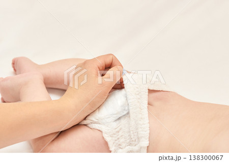 Caucasian Adult Changing Diaper Of Caucasian Baby On A Soft White Surface In A Gentle, Caring 138300067