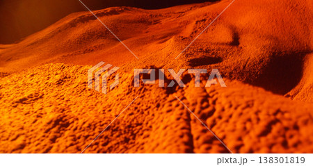 Alien landscape orange sand desert dune abstract terrain macro texture dramatic light surreal nature rocky surface dry ground extreme closeup Mysterious alien landscape with rugged orange sand 138301819