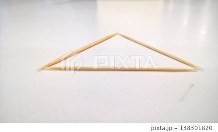 Toothpick triangle minimalist geometry white background three wood shape simple Toothpick triangle minimalist geometry white background with three wood stick shape creating clean simple abstract 138301820