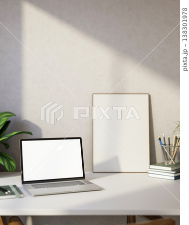 White screen laptop with book and pencil aside photo frame canvas on table and sunlight on room wall White screen laptop with book and pencil aside photo frame canvas on table and sunlight on room wall 138301978