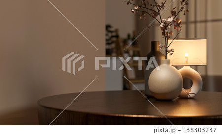 Flower vases and illuminating lamp on round wooden table across wall and window curtain in dim room. 138303237